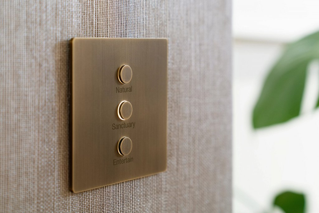 Engraved antique brass Lutron Alisse keypad with Natural, Sanctuary, and Entertain scenes