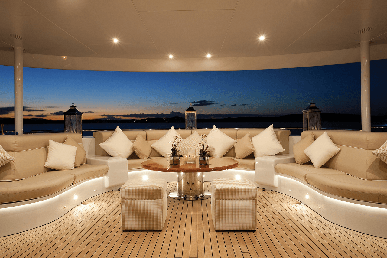 Super yacht deck lounge with layered evening lighting